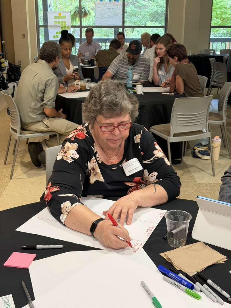 A participant mapping ideas on paper during a working session